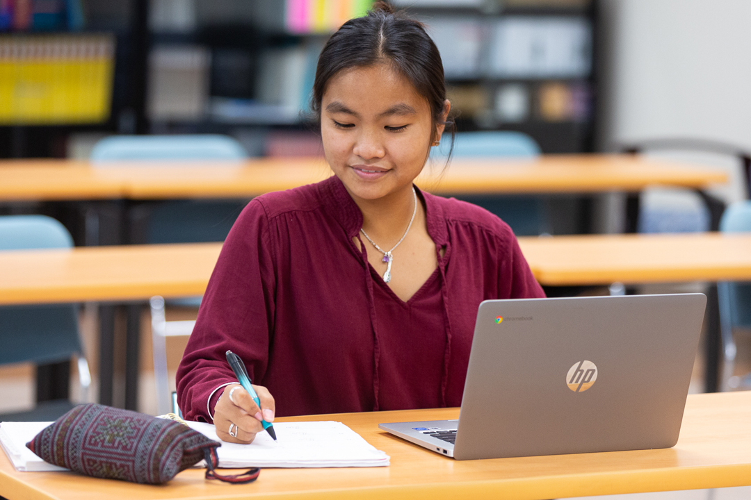 female student checking her laptop screen